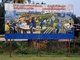 Laos: Construction and Industry in Laos. Revolutionary Socialist realist-style political poster on the streets of Vientiane